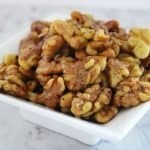 white dish of roasted walnuts.