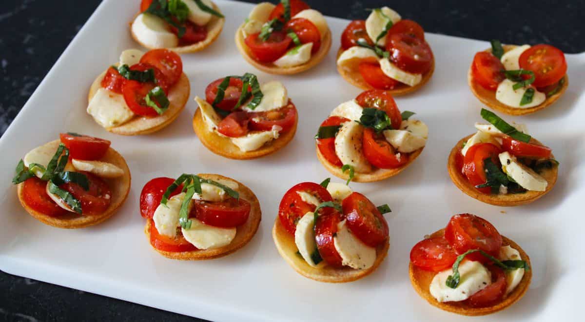 Tartlets on a white platter. 