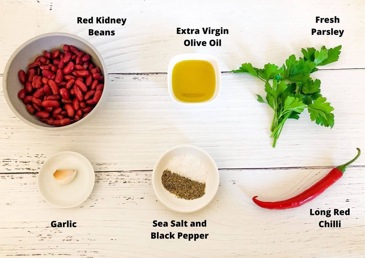 Ingredients on white timber background used to make red kidney bean dip.