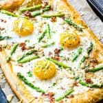 breakfast pizza on parchment paper.