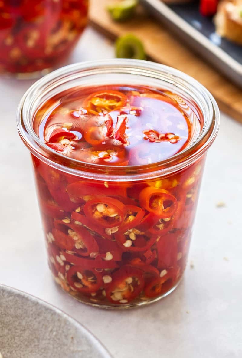 up close shot of jar of chillies with no lid.