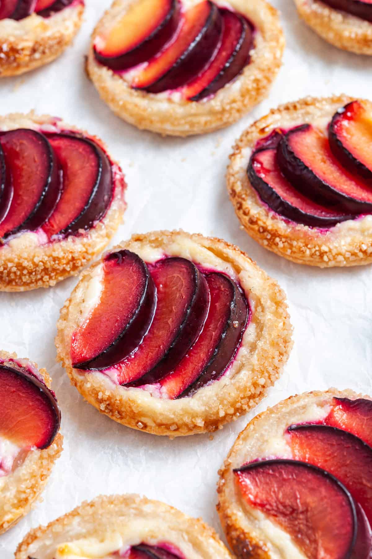 up close shot of tarts on baking paper.