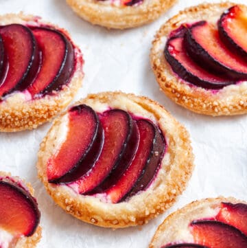 up close shot of tarts on baking paper.