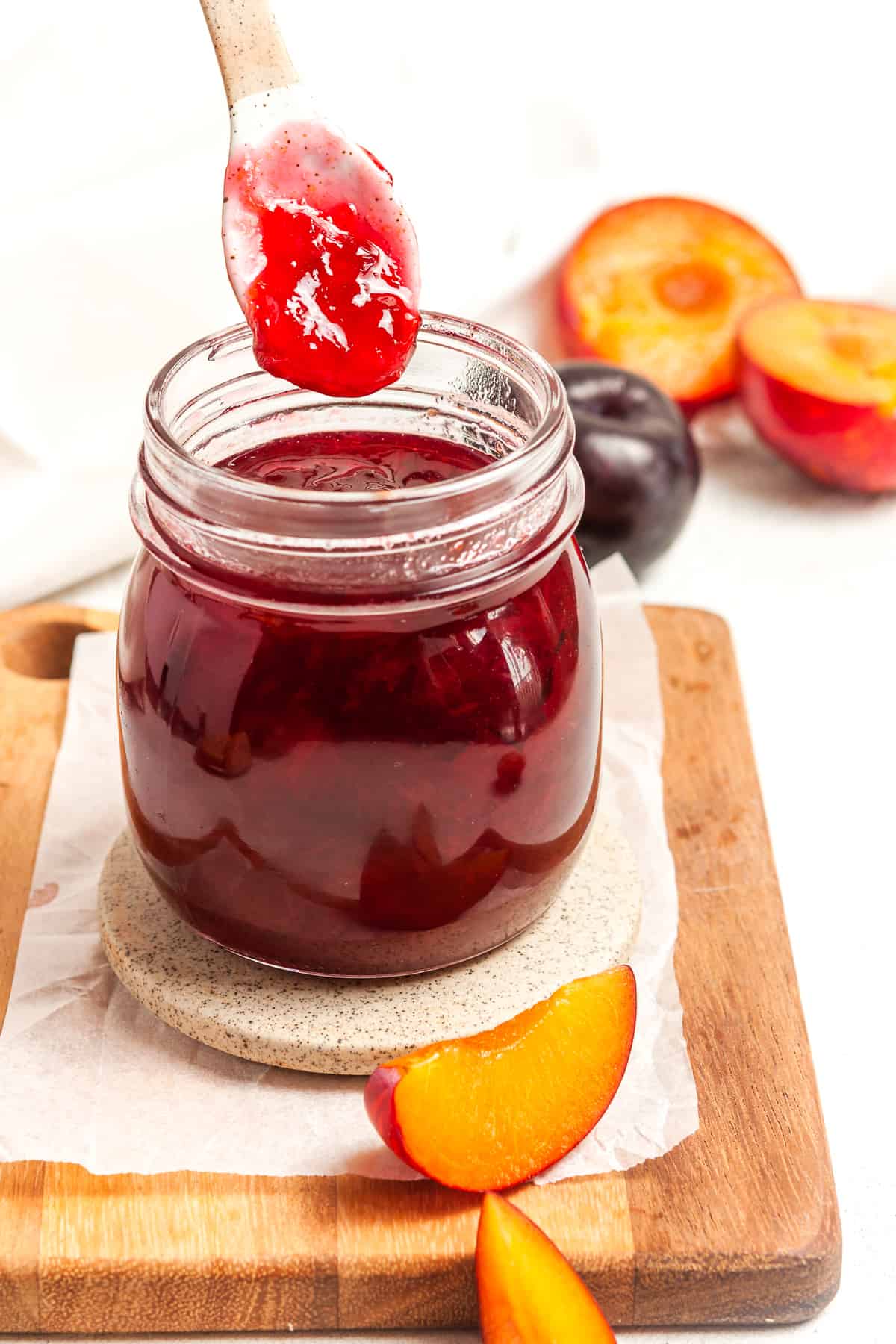 Spoon dipping into a jar of jam.