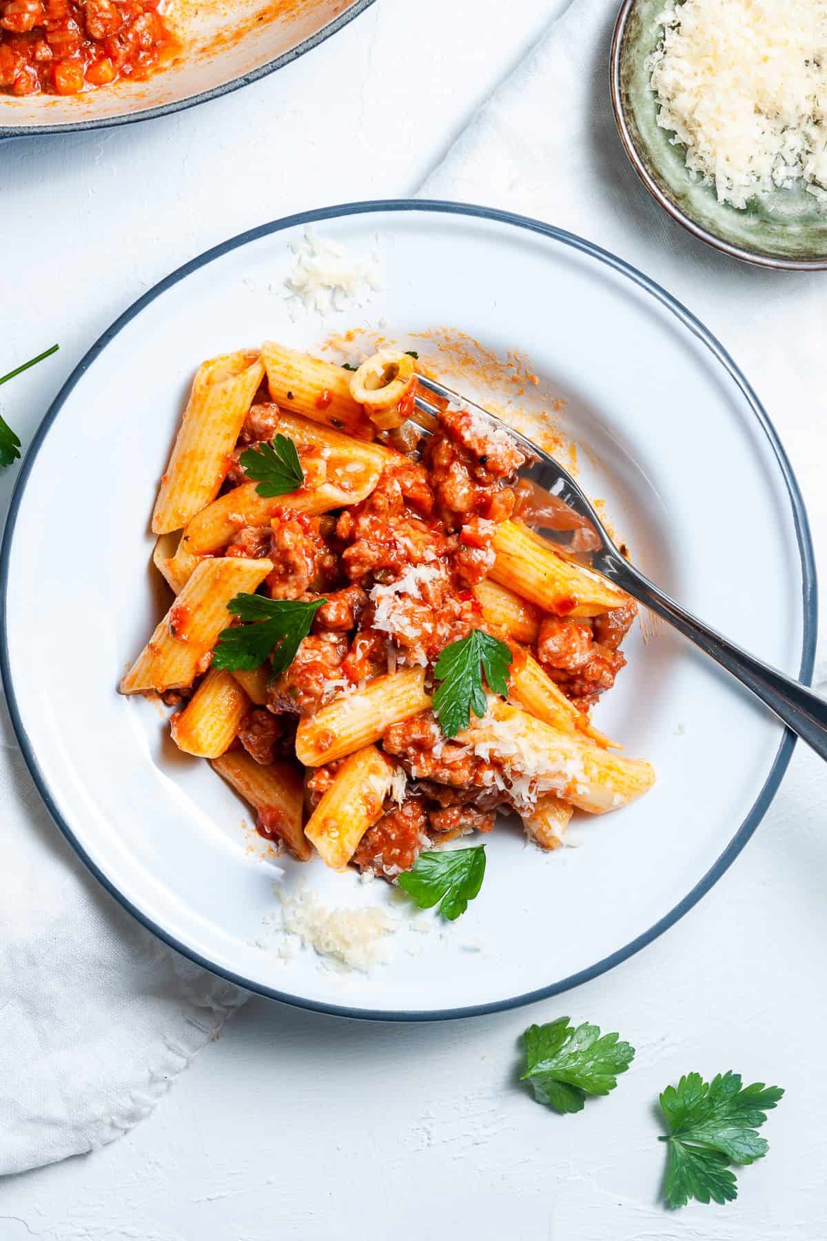 Dish of penne pasta, tossed in the ragu.