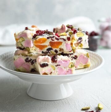 Round white plate with cut pieces of rocky road.