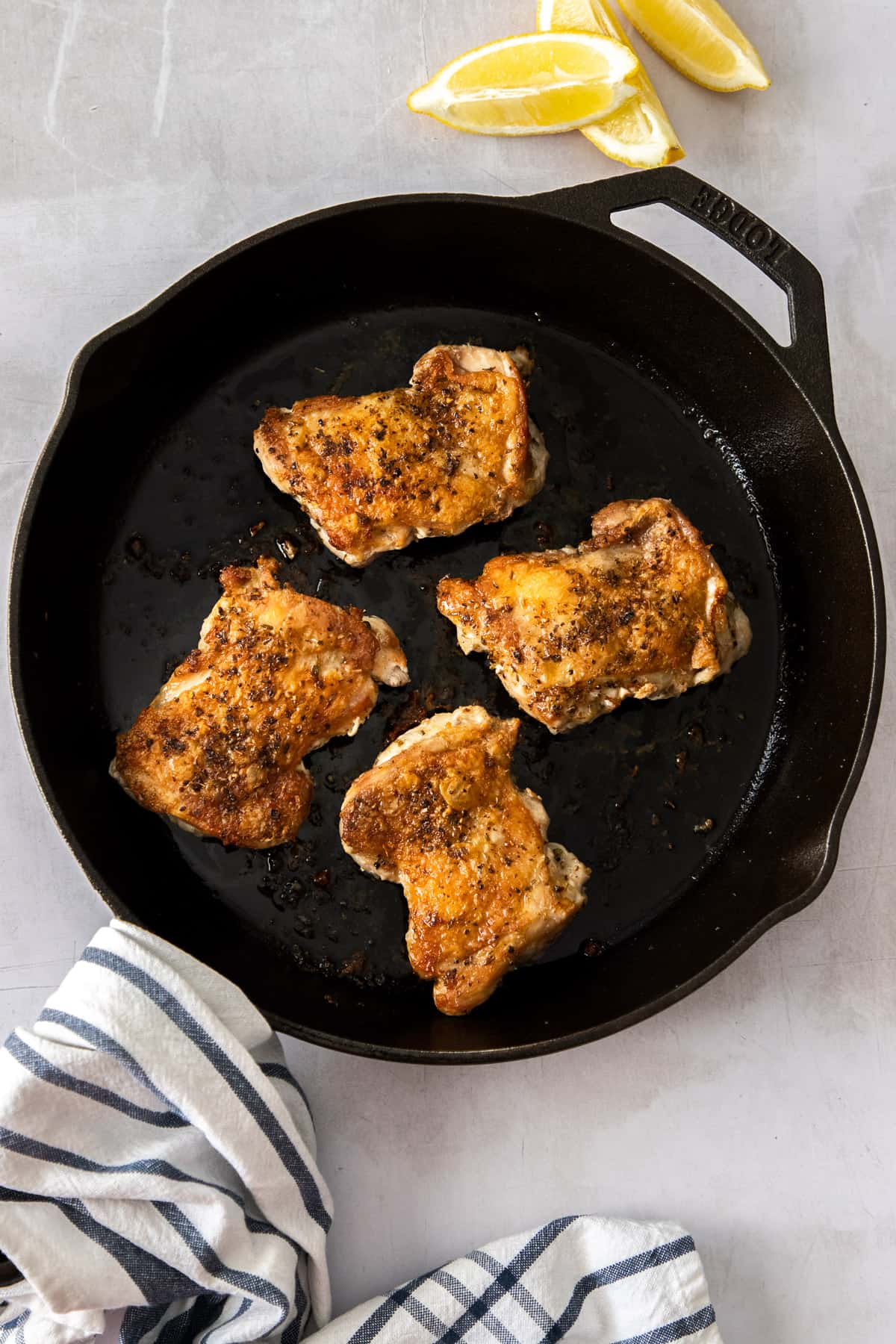 Cooked thighs in cast iron pan.