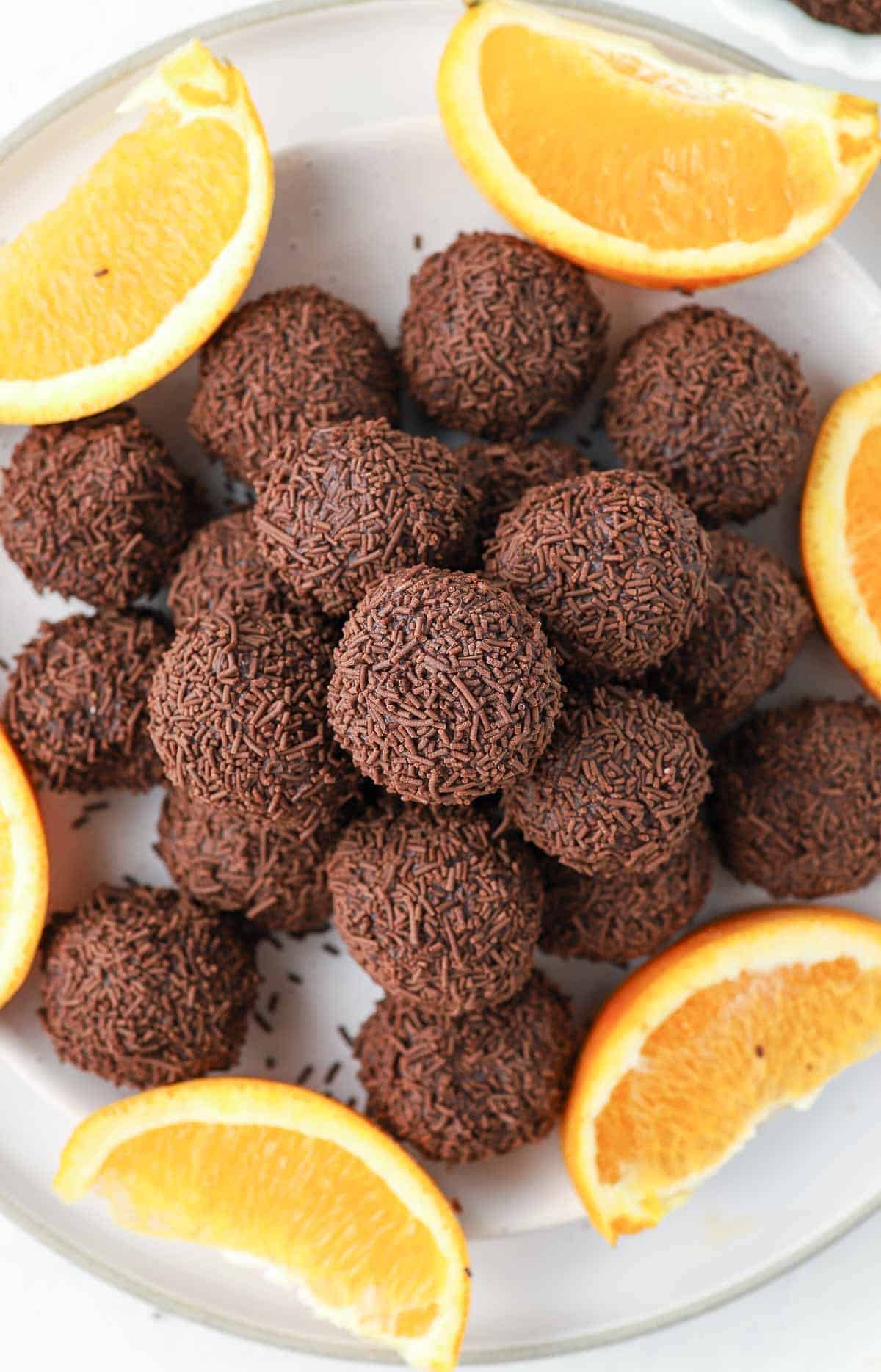 Plate of truffles, garnished with some orange slices.