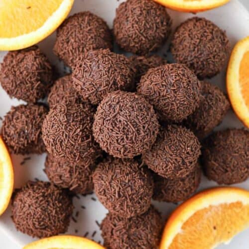 Plate of truffles, garnished with some orange slices.