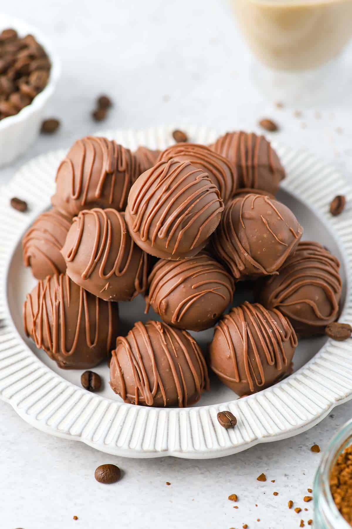 Plate of truffles sprinkled with some coffee beans.