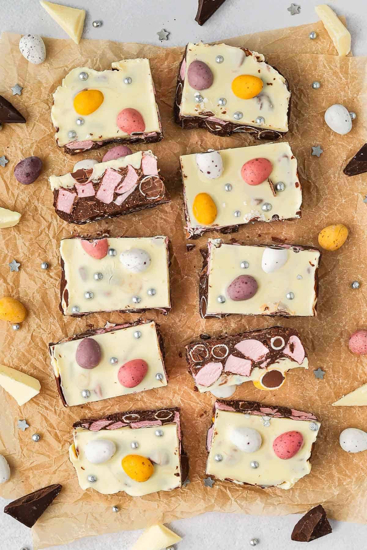 The rocky road cut into ten pieces, sitting on some baking paper with extra mini eggs around the edge.