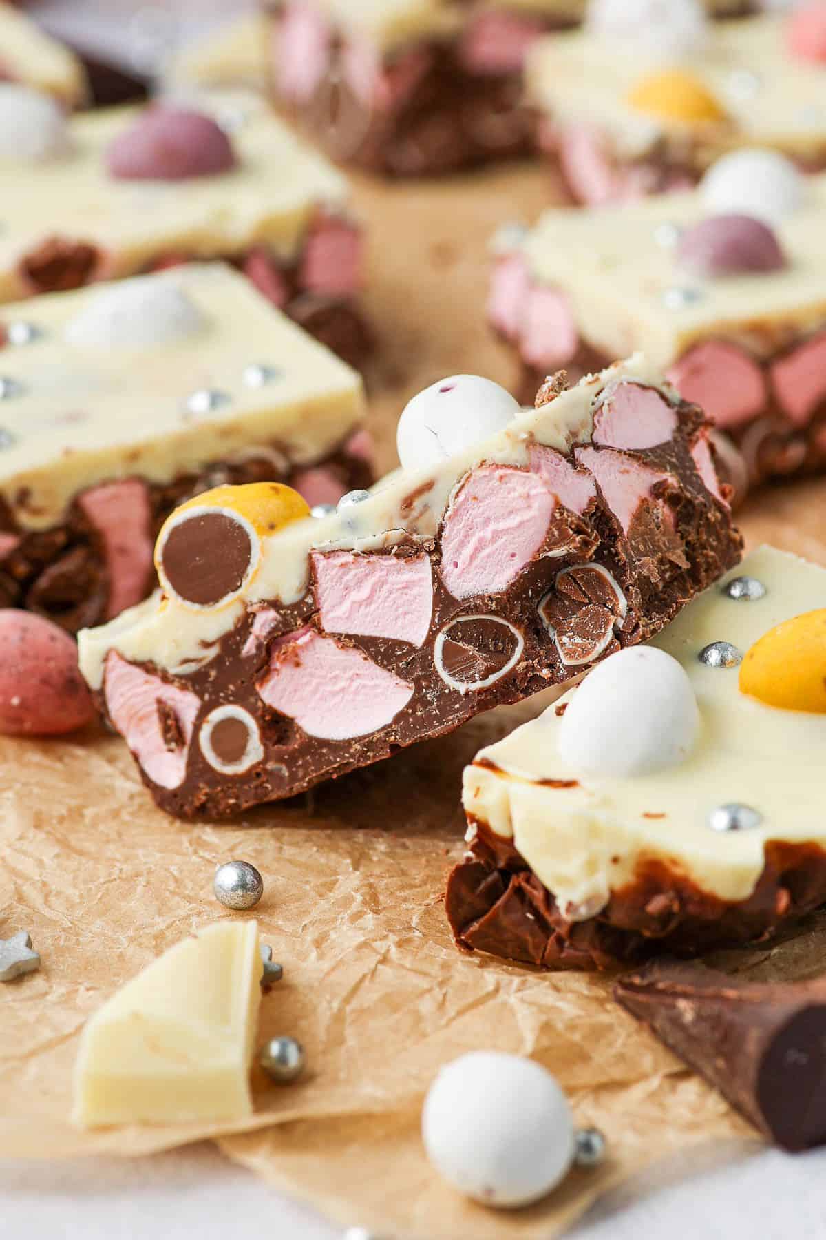 A piece of rocky road sitting on another piece on an angle to show the filling.