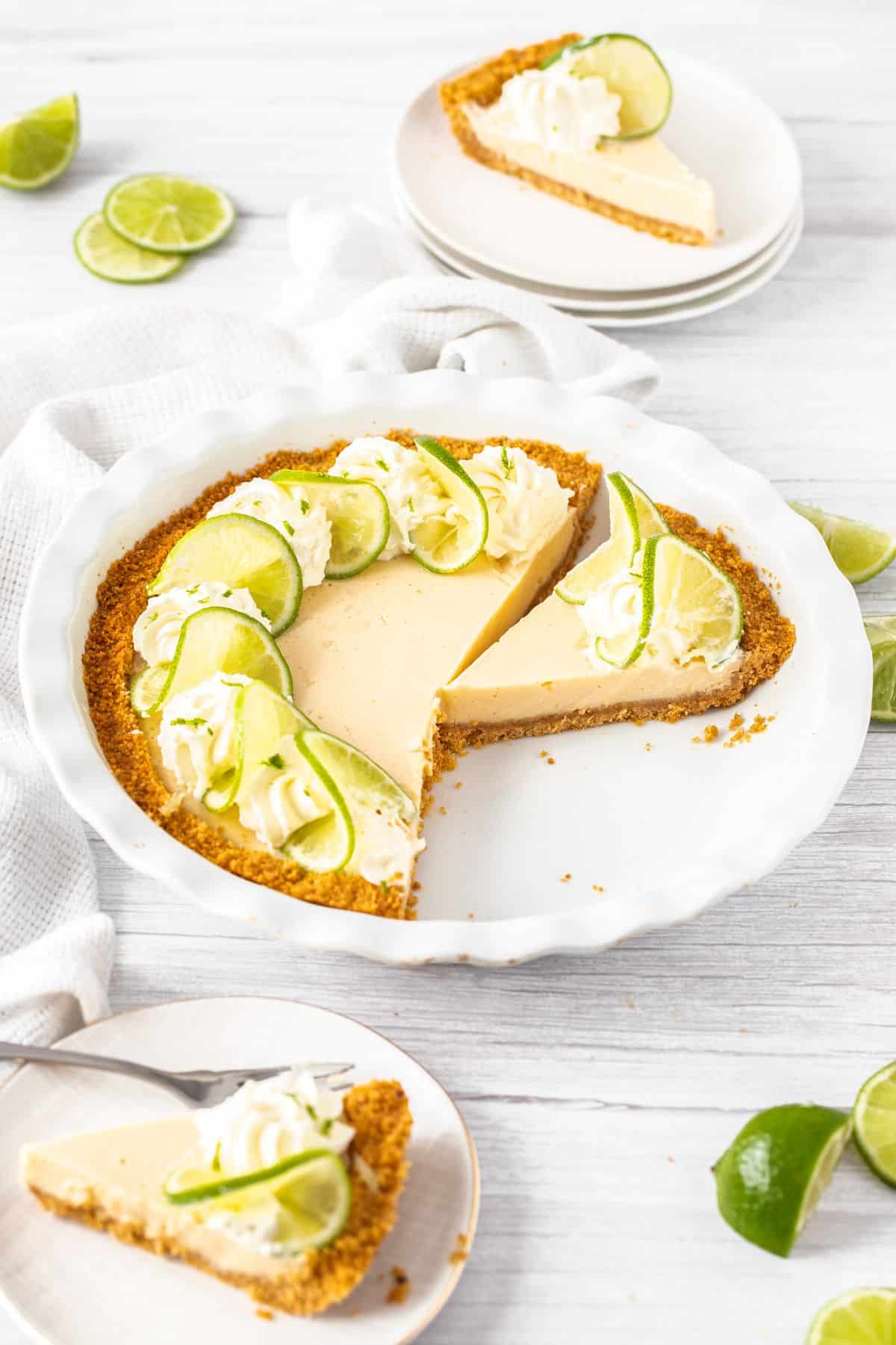 Key Lime Pie, with some slices removed sitting on plates.