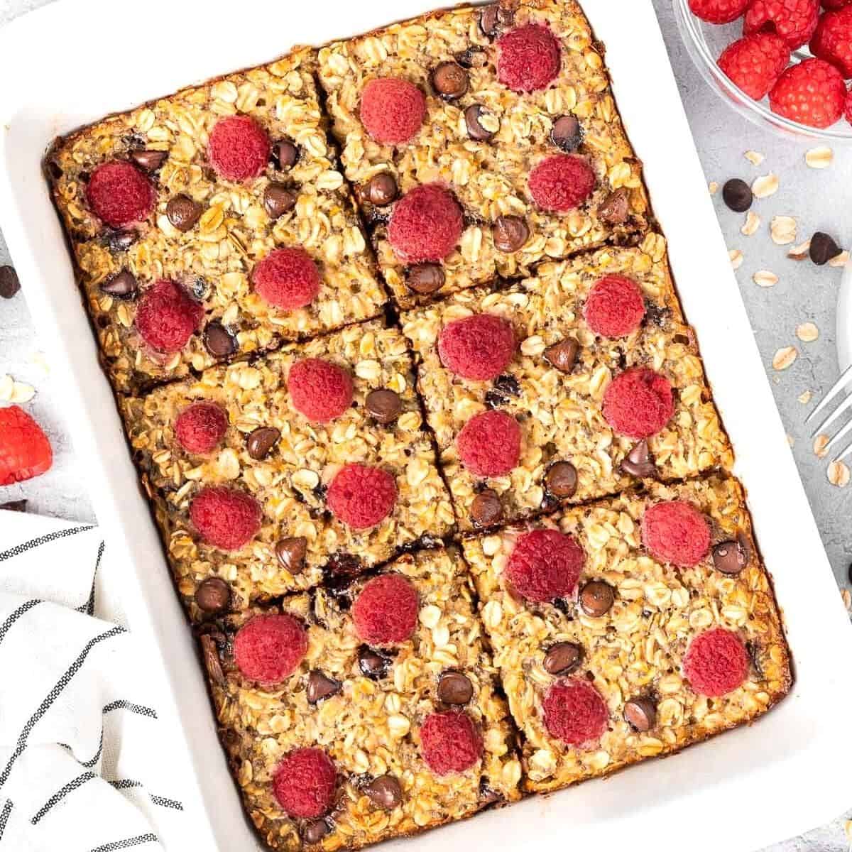 White rectangular dish of baked oatmeal, cut into six pieces.