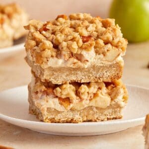 Stack of two Apple Oatmeal Bars on a small round white plate.