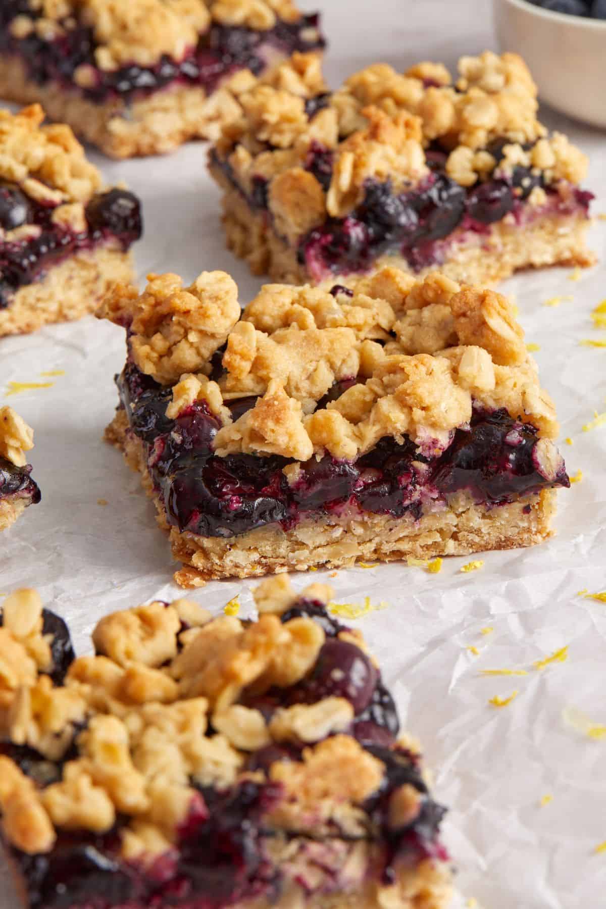 Cut squares of Blueberry Oatmeal Bars on some baking paper.