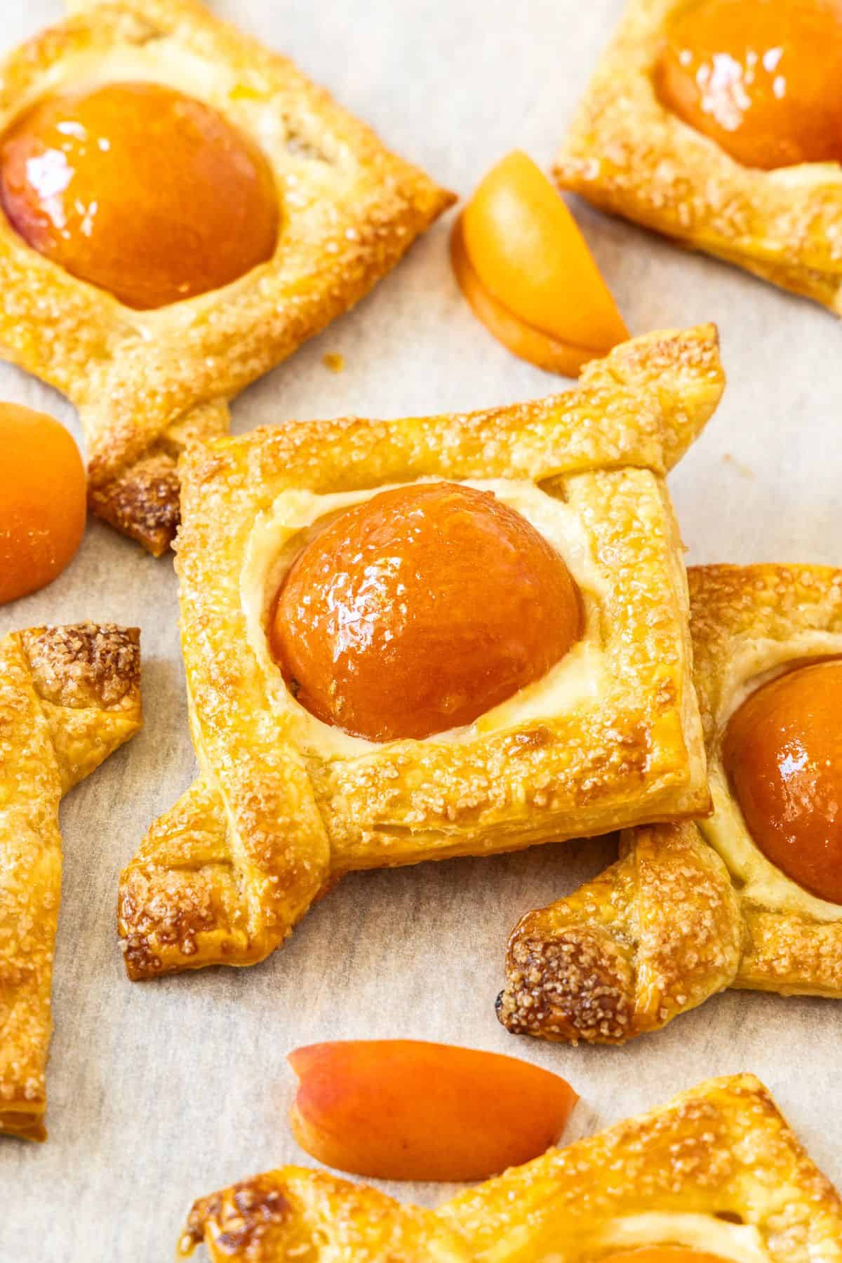 Baked Apricot and Cream Cheese Pastries on some baking paper.