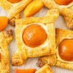 Baked Apricot and Cream Cheese Pastries on some baking paper.