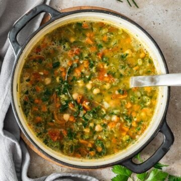 Large saucepan with the cooked Chickpea Soup, with a soup ladle resting in the pot.