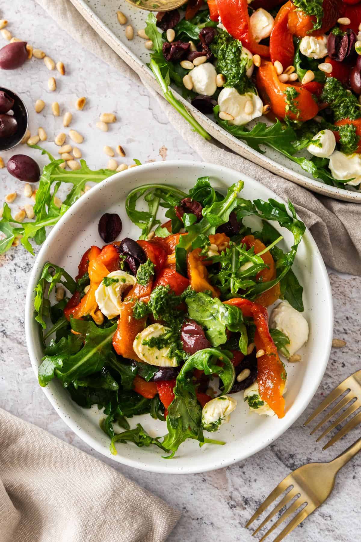 A serve of Roasted Capsicum (Red Pepper) Salad on a round white plate.