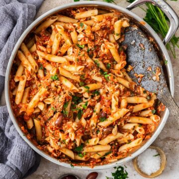 Large pan with the cooked Spicy Tuna and Tomato Pasta, ready to serve with a wooden spoon.