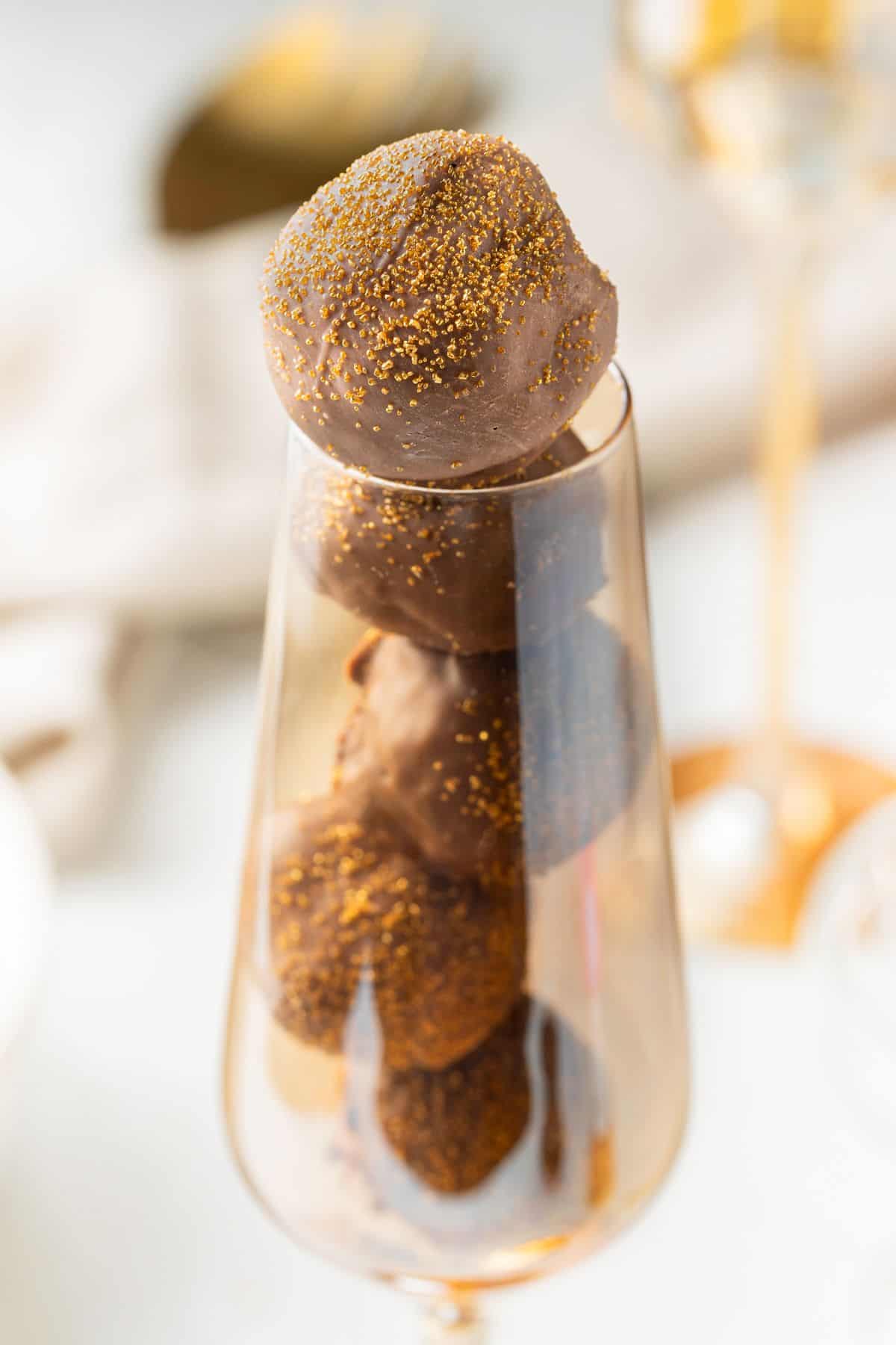 Five Champagne Truffles in a gold champagne flute.