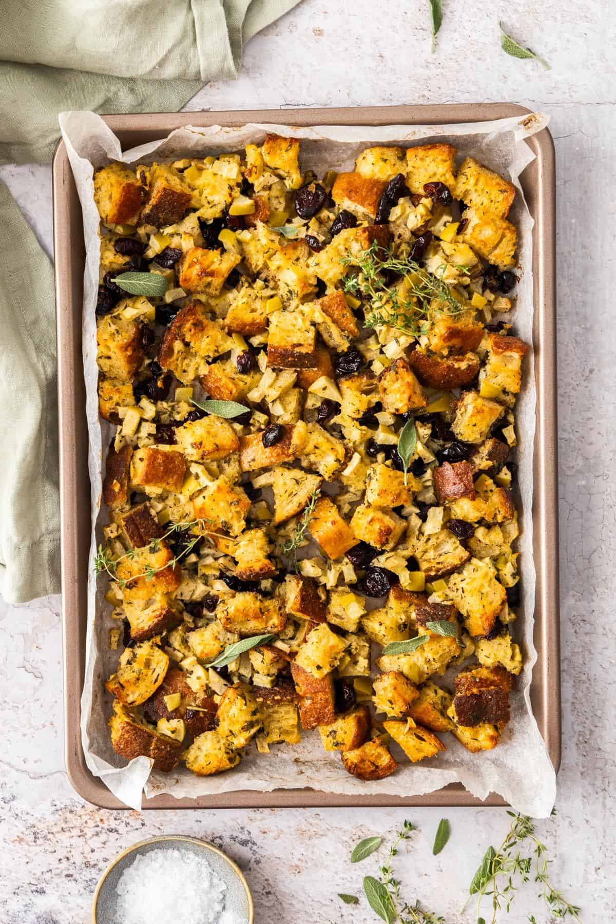 Crispy Sheet Pan Stuffing, sitting on a bench top with a green towel on the edge.