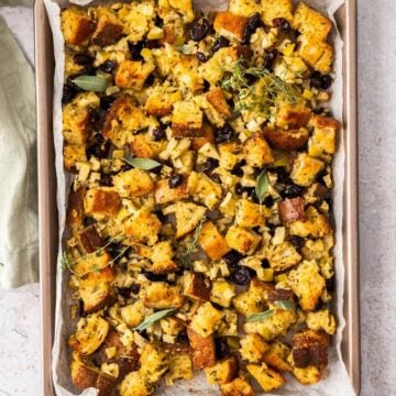 Crispy Sheet Pan Stuffing, sitting on a bench top with a green towel on the edge.