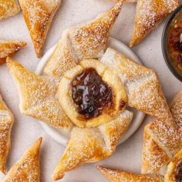 Fruit Mince Pinwheels on a bench top, with one sitting on a small white dish.