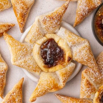 Fruit Mince Pinwheels on a bench top, with one sitting on a small white dish.