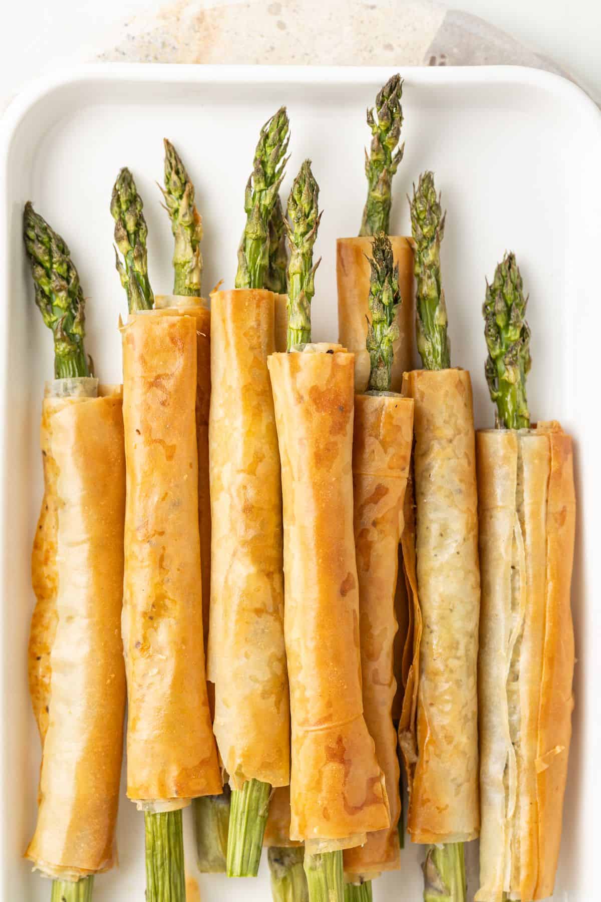 White Platter of Asparagus Filo Rolls.