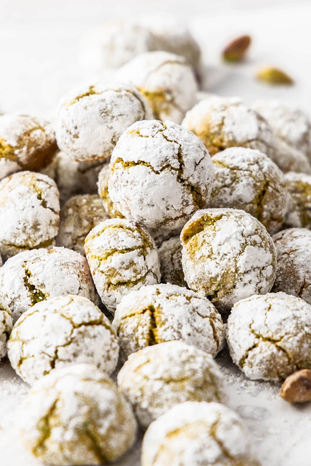 Freshly baked Gluten-Free Pistachio Cookies in a pile on some baking paper.
