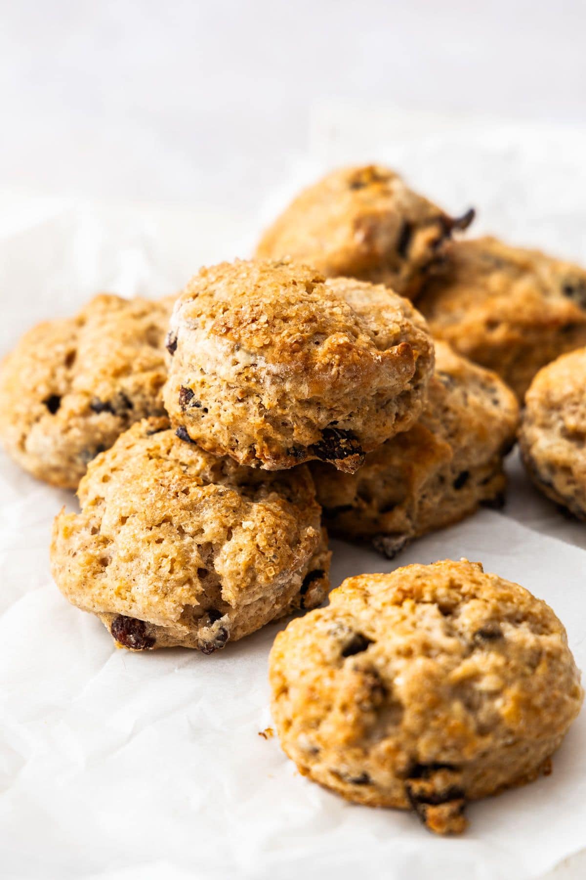 Freshly baked Sultana Scones stacked on some baking paper.