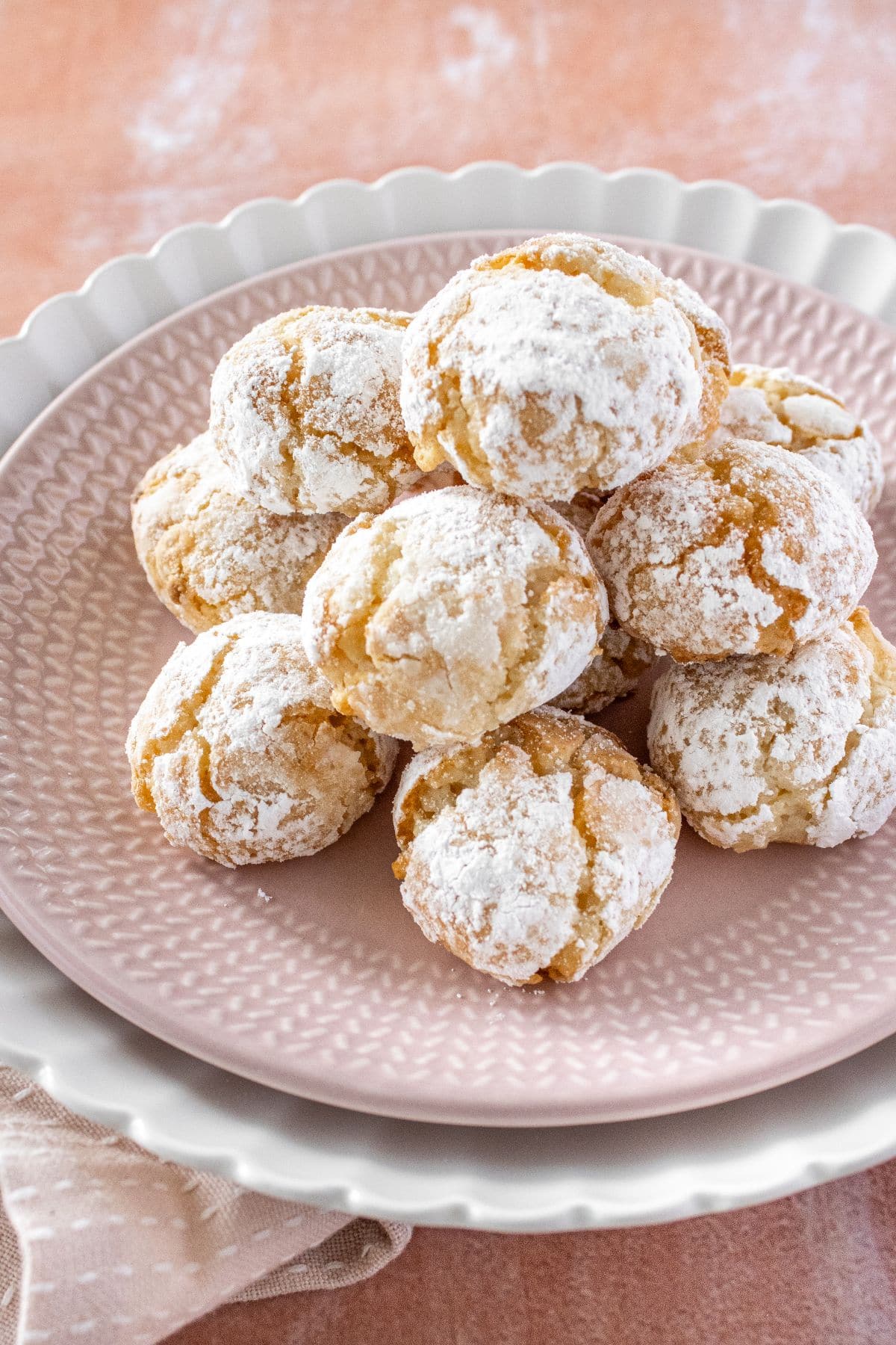 Round pink plate of Gluten-Free Macadamia Cookies.
