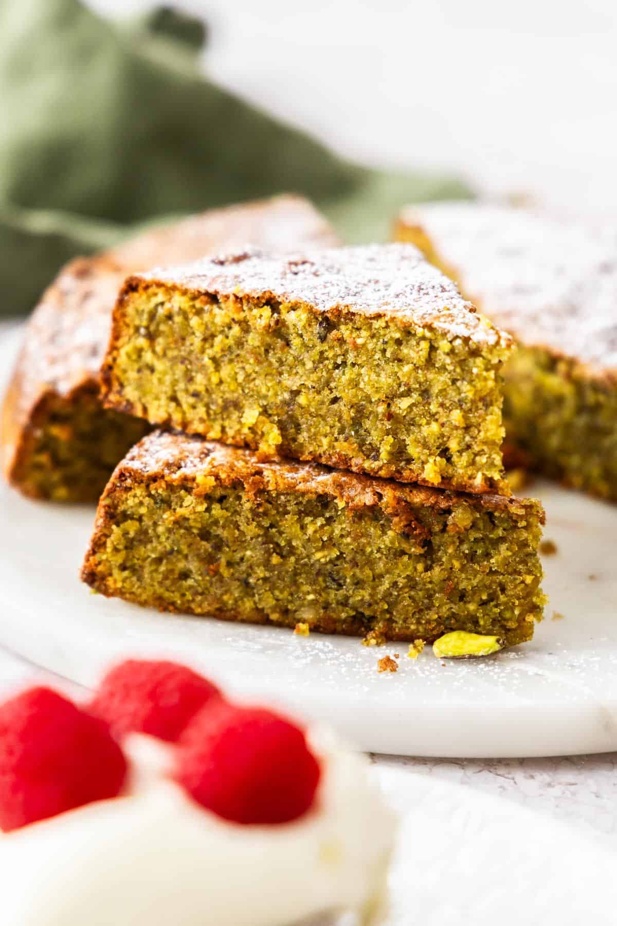 Two pieces of Pistachio Cake stacked on top of each other.