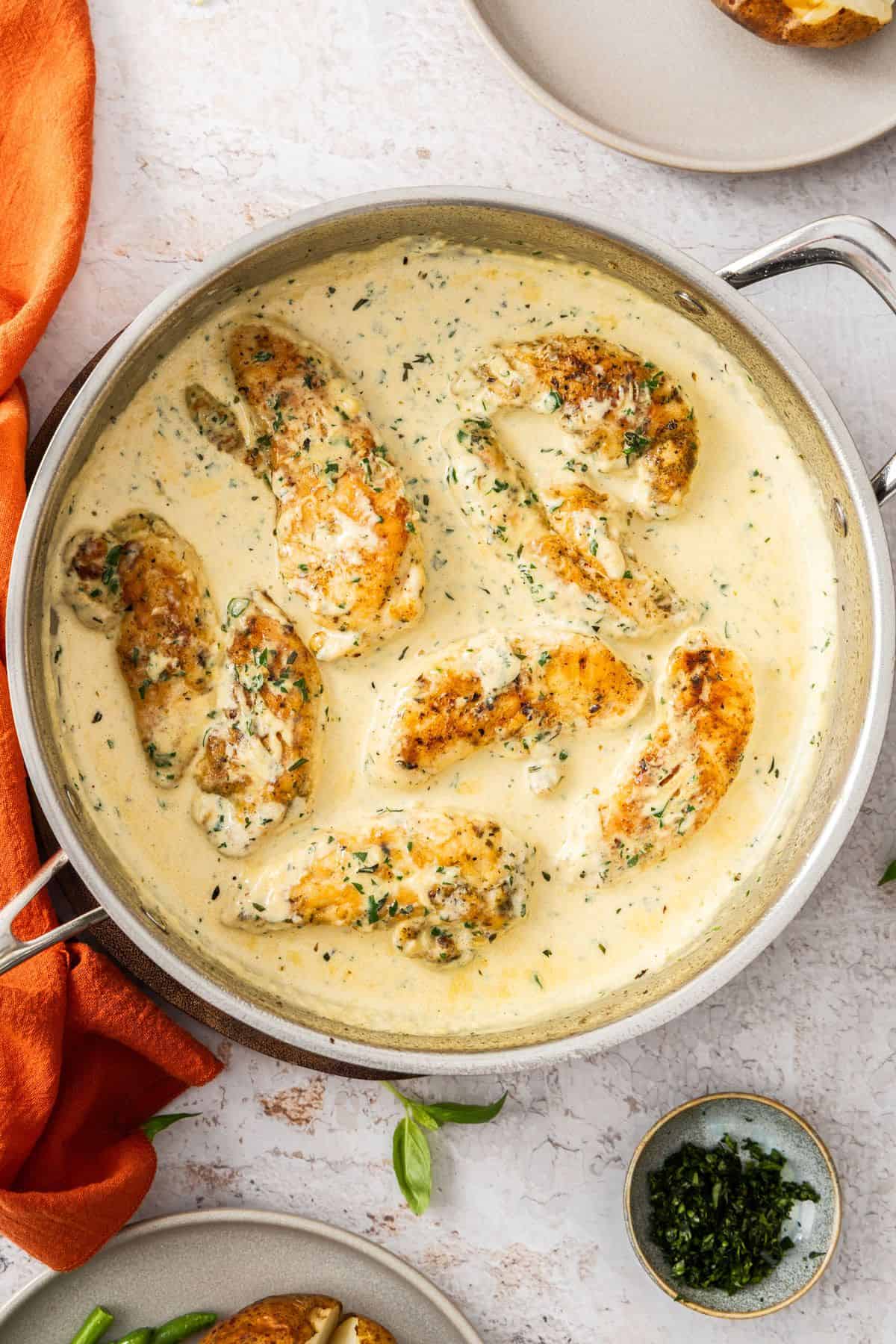 Large frying pan with Creamy Herb Chicken, ready to serve.