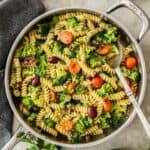 Large frying pan of Broccoli and Tomato Pasta with a spoon resting in the pan.